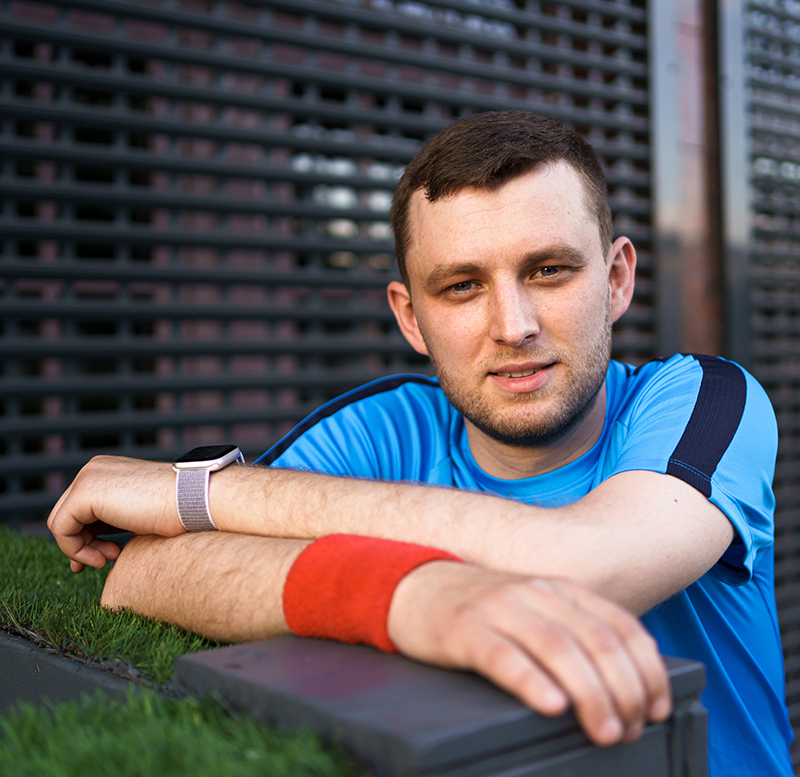 Happy smiling mother and her cute emotional little daughter child in white shirts and denim jeans are hugging and having fun outdoor in nature at countryside. Spending summer time with family.