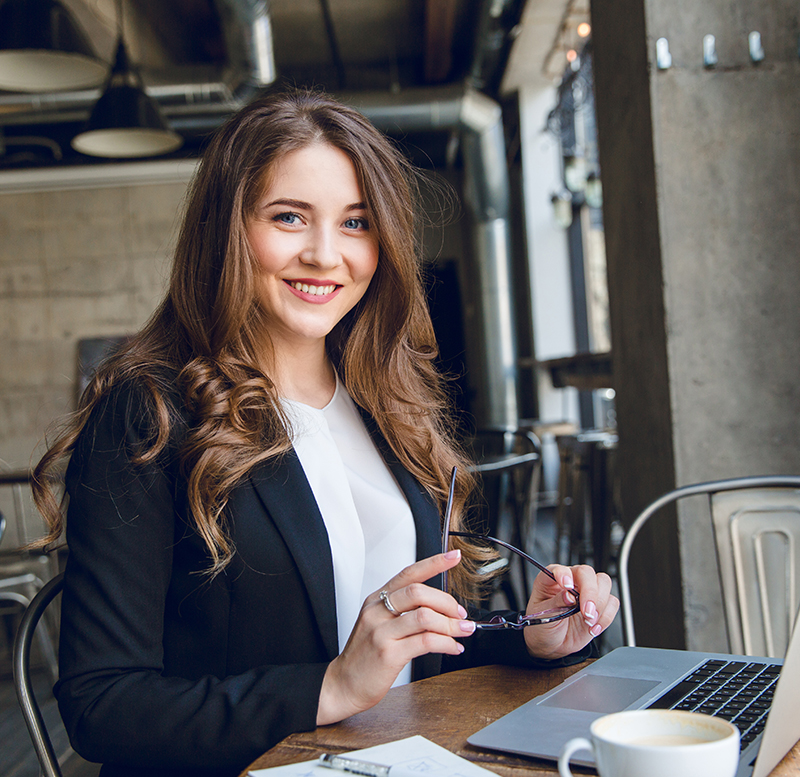 Happy smiling mother and her cute emotional little daughter child in white shirts and denim jeans are hugging and having fun outdoor in nature at countryside. Spending summer time with family.