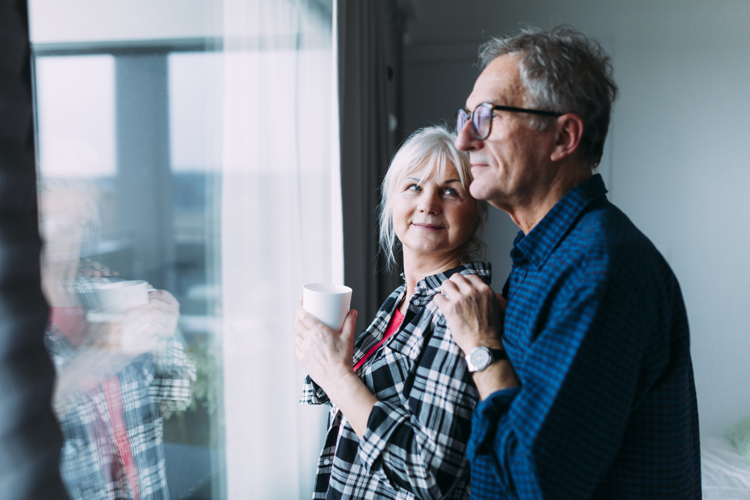 elderly-couple-retirement-home-front-window